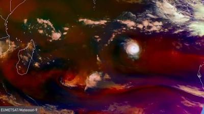 A satellite image showing a tropical cyclone Freddy over the Indian Ocean with distinct cloud formations and colorful atmospheric patterns. Coastlines of surrounding regions are partially visible.